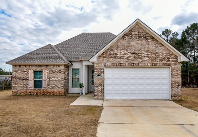 view of front facade featuring a garage and a front lawn