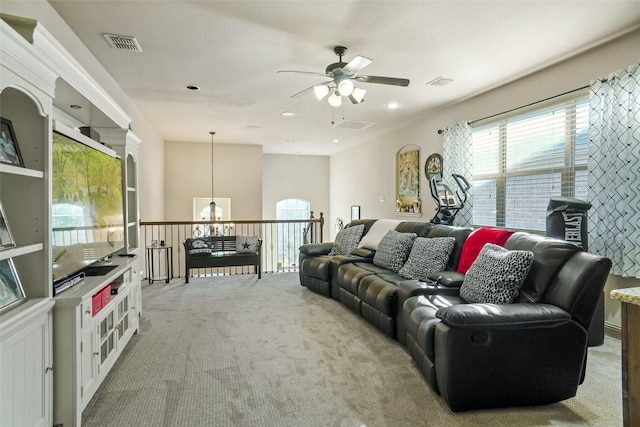 carpeted living room with ceiling fan