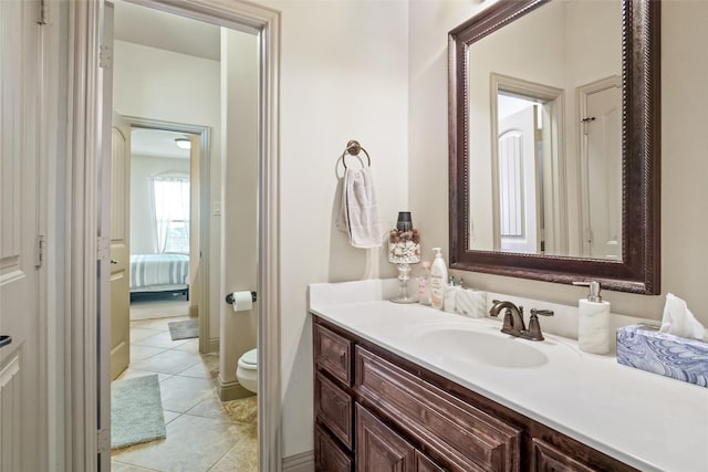 bathroom with tile patterned flooring, vanity, and toilet