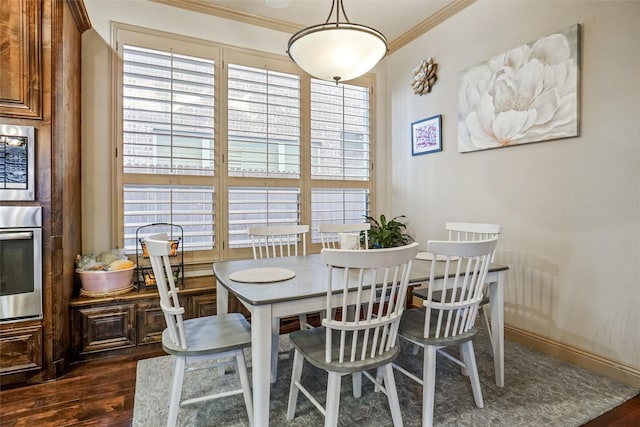 dining space with ornamental molding and dark hardwood / wood-style flooring