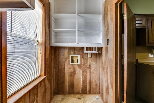 laundry area with washer hookup and wooden walls