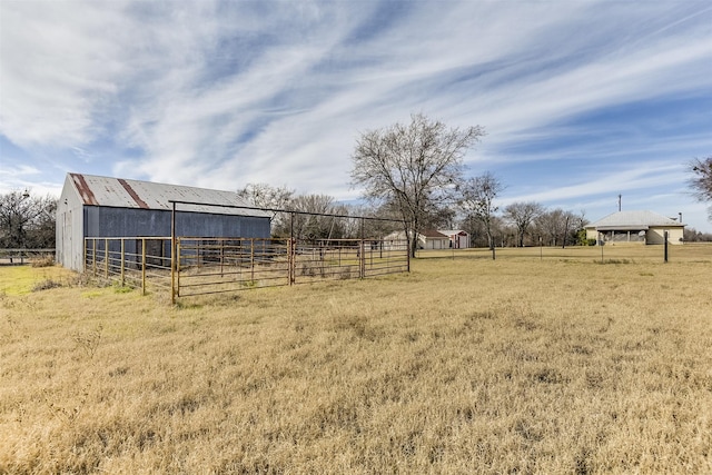 view of yard with an outbuilding and a rural view