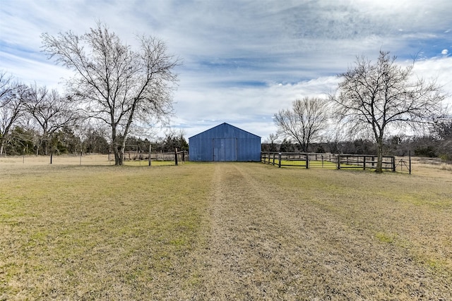 view of yard with an outbuilding and a rural view