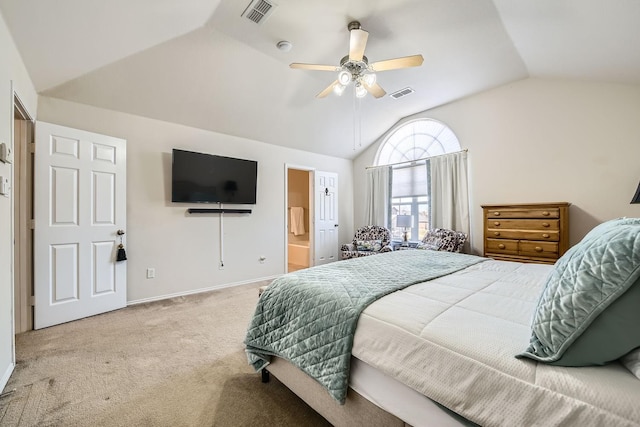 carpeted bedroom with vaulted ceiling, ceiling fan, and ensuite bathroom