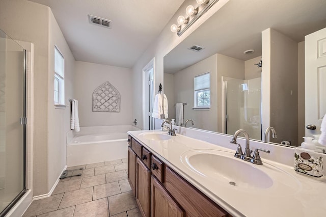 bathroom with tile patterned floors, shower with separate bathtub, and vanity