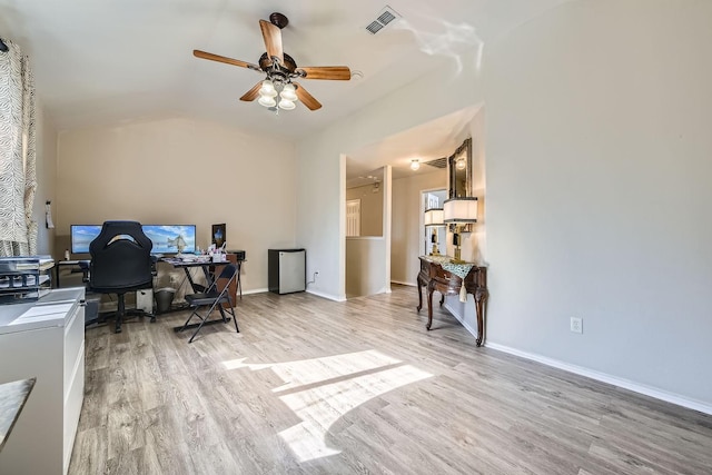 home office featuring vaulted ceiling, ceiling fan, and light wood-type flooring