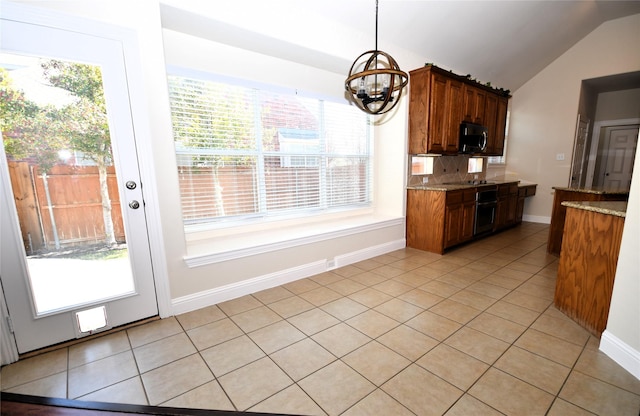 kitchen featuring light stone counters, backsplash, vaulted ceiling, and light tile patterned flooring