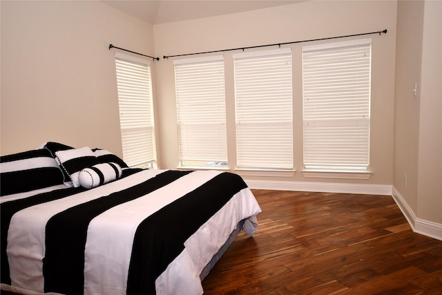 bedroom with dark wood-type flooring