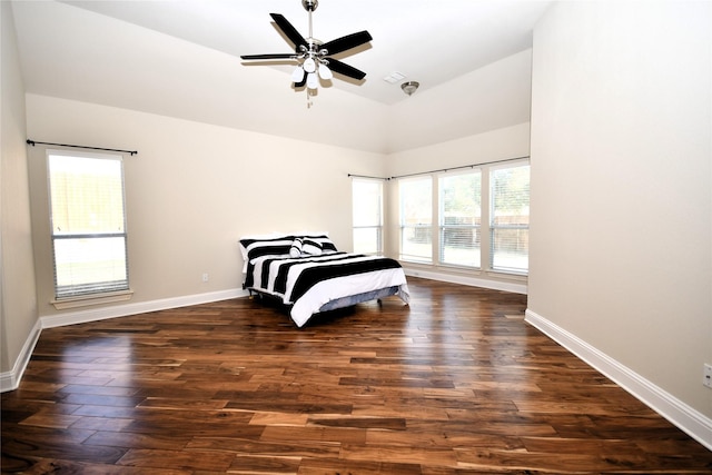 bedroom with lofted ceiling, dark wood-type flooring, and ceiling fan