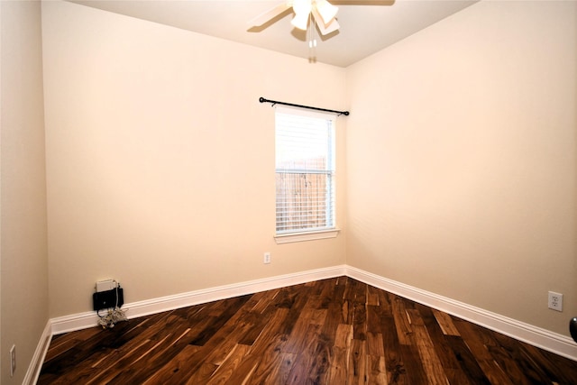 spare room featuring dark wood-type flooring and ceiling fan