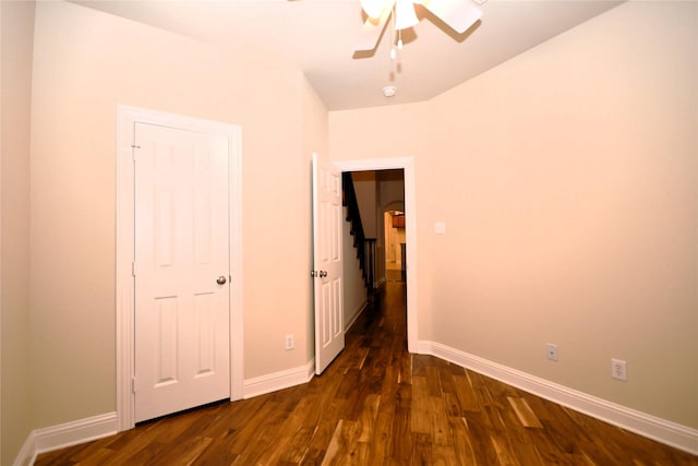 unfurnished bedroom with dark wood-type flooring and ceiling fan