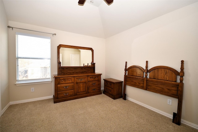 carpeted bedroom featuring ceiling fan and vaulted ceiling