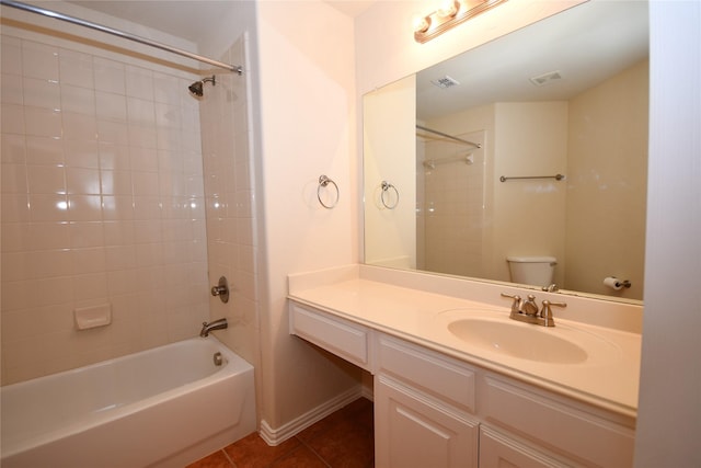 full bathroom featuring vanity, toilet, tiled shower / bath combo, and tile patterned flooring