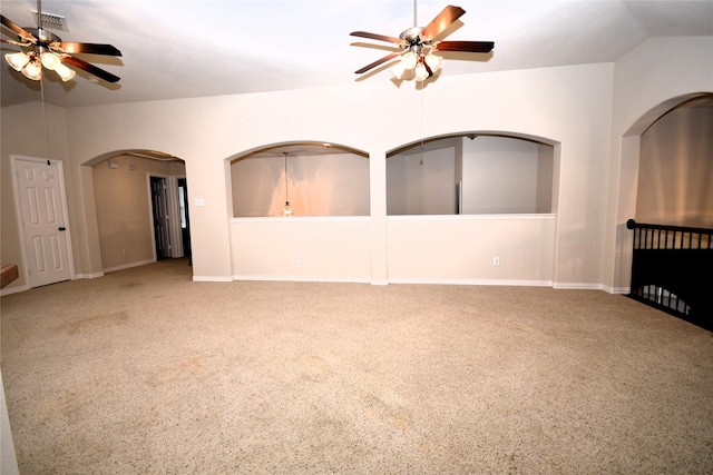 carpeted spare room with ceiling fan and lofted ceiling