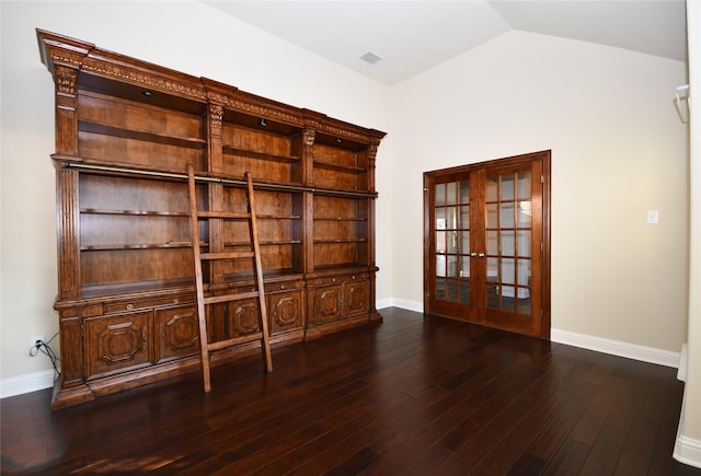 unfurnished office featuring lofted ceiling, dark wood-type flooring, and french doors