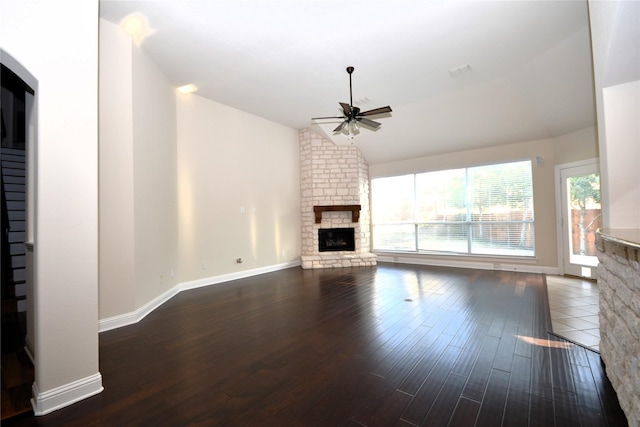 unfurnished living room featuring dark hardwood / wood-style floors, ceiling fan, lofted ceiling, and a fireplace