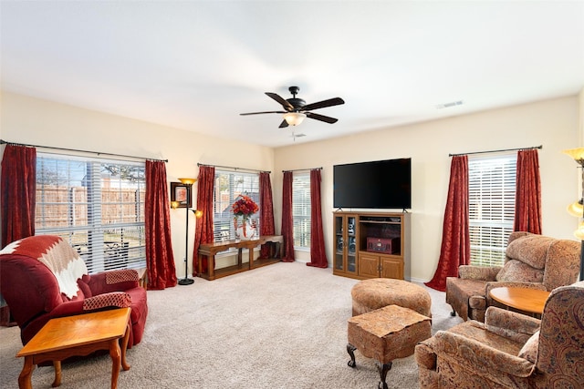 carpeted living room featuring ceiling fan