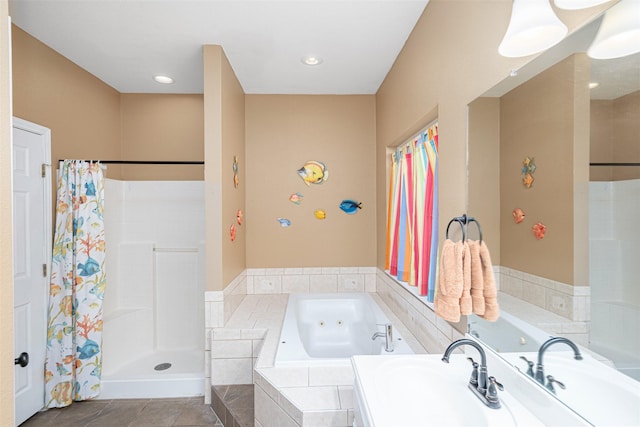 bathroom featuring plus walk in shower, sink, and tile patterned floors