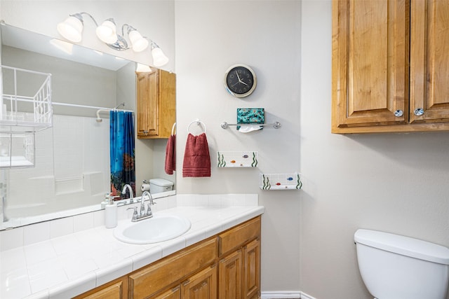 bathroom with walk in shower, vanity, and toilet