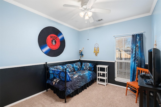 carpeted bedroom with ceiling fan and ornamental molding