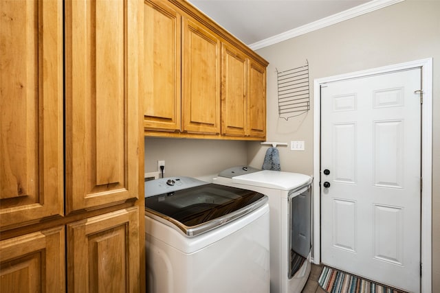 laundry area with crown molding, cabinets, and washer and dryer