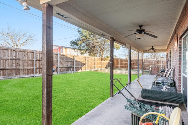 view of yard featuring ceiling fan and a patio area