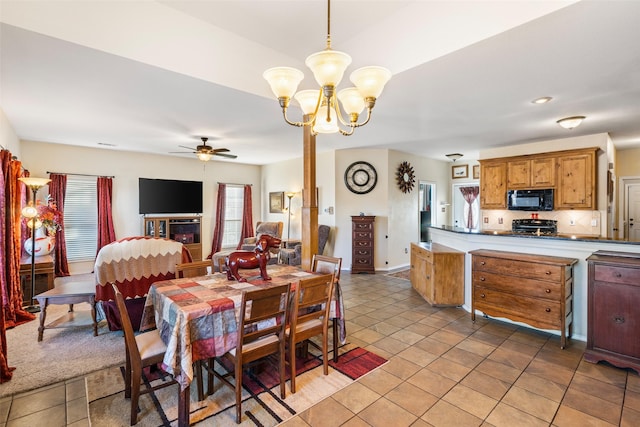 dining area featuring light tile patterned flooring and ceiling fan with notable chandelier