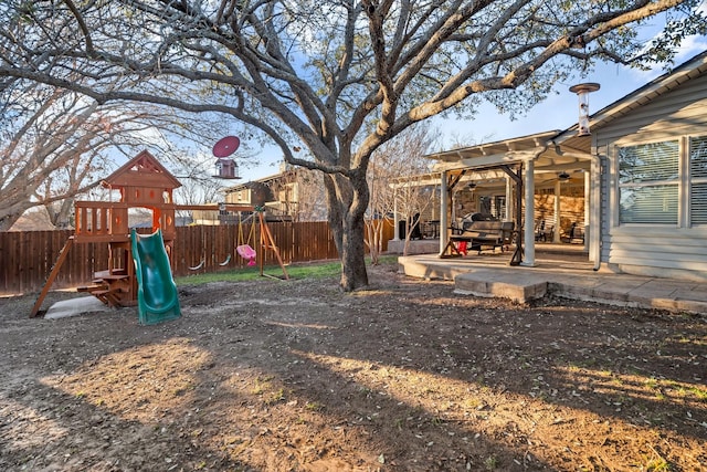 view of yard with a playground and a patio area