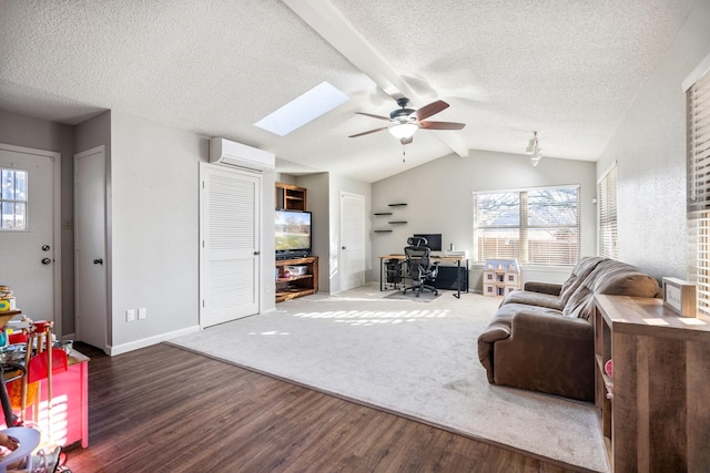 living room with lofted ceiling with skylight, a wall mounted AC, a textured ceiling, dark hardwood / wood-style floors, and ceiling fan