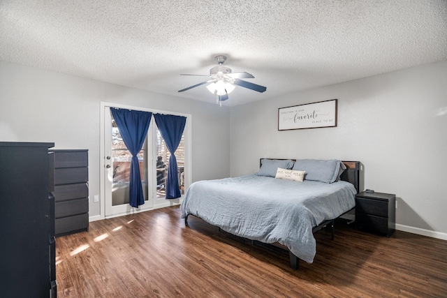 bedroom featuring ceiling fan, dark wood-type flooring, access to outside, and a textured ceiling