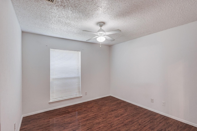 unfurnished room with ceiling fan, a textured ceiling, and dark hardwood / wood-style flooring