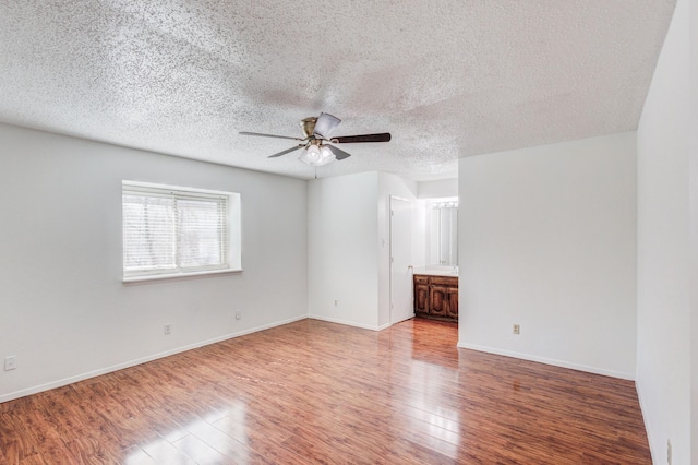 unfurnished room featuring a textured ceiling, wood-type flooring, and ceiling fan