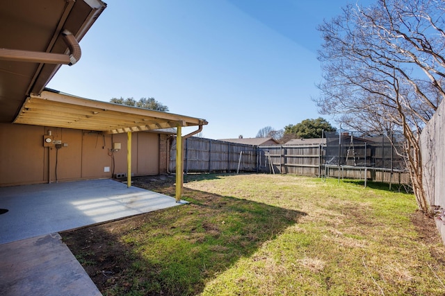 view of yard with a patio area and a trampoline