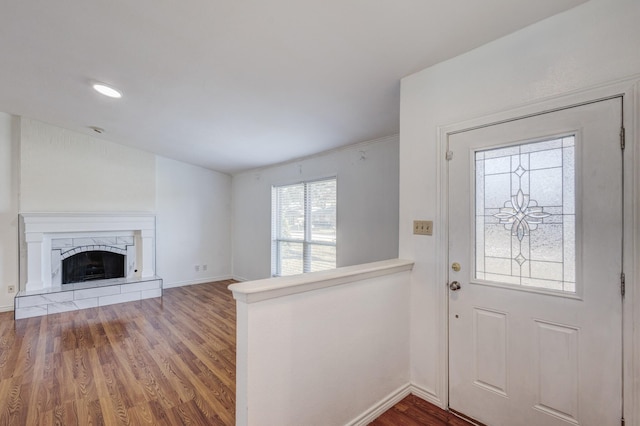 entryway featuring hardwood / wood-style flooring and a premium fireplace