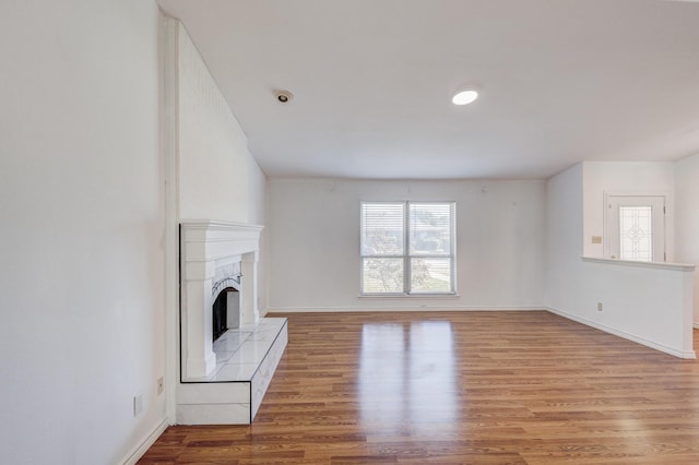 unfurnished living room with light wood-type flooring and a fireplace