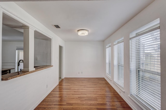 dining space with wood-type flooring