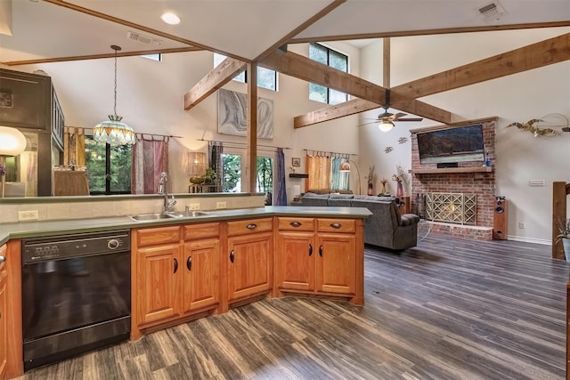 kitchen with pendant lighting, sink, dark hardwood / wood-style floors, black dishwasher, and a fireplace