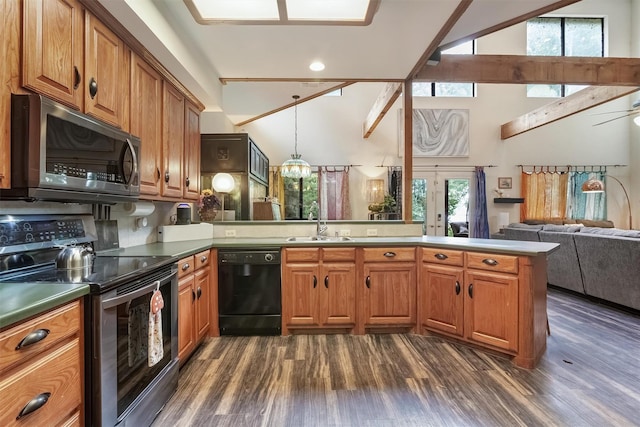 kitchen featuring appliances with stainless steel finishes, a towering ceiling, hanging light fixtures, kitchen peninsula, and dark wood-type flooring