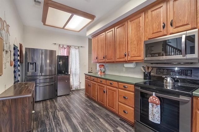 kitchen with dark hardwood / wood-style floors and appliances with stainless steel finishes