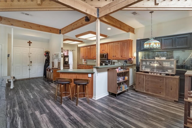 kitchen with pendant lighting, beam ceiling, dark hardwood / wood-style flooring, and decorative backsplash