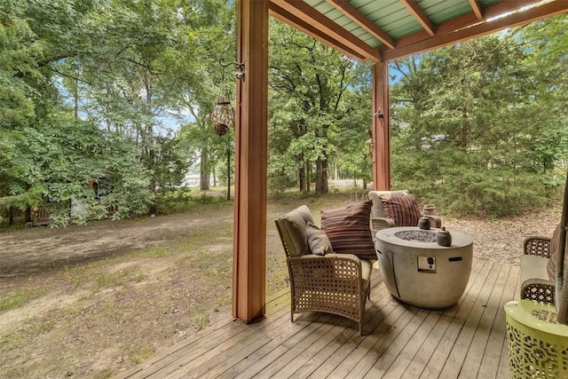 wooden deck featuring an outdoor fire pit