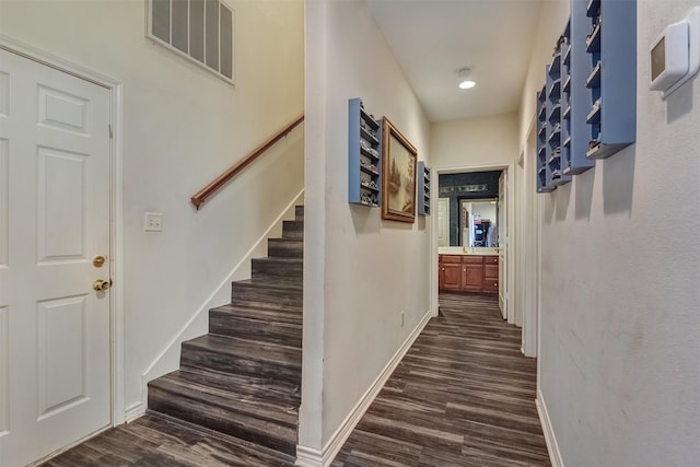 corridor featuring dark wood-type flooring