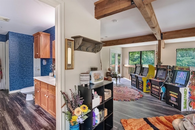 interior space featuring beamed ceiling and dark wood-type flooring