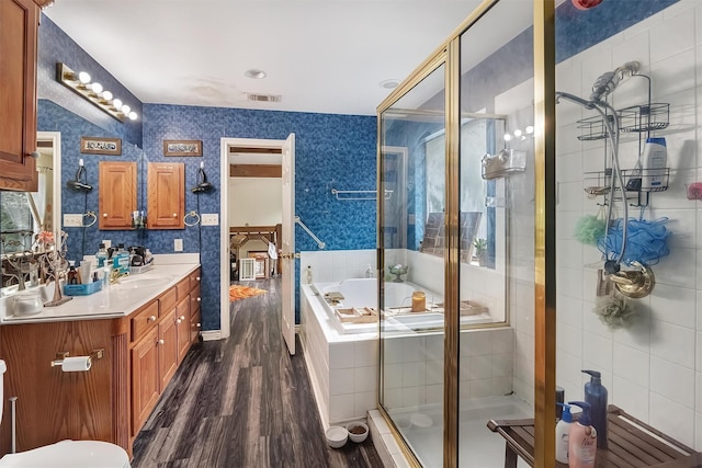 bathroom with independent shower and bath, vanity, and wood-type flooring