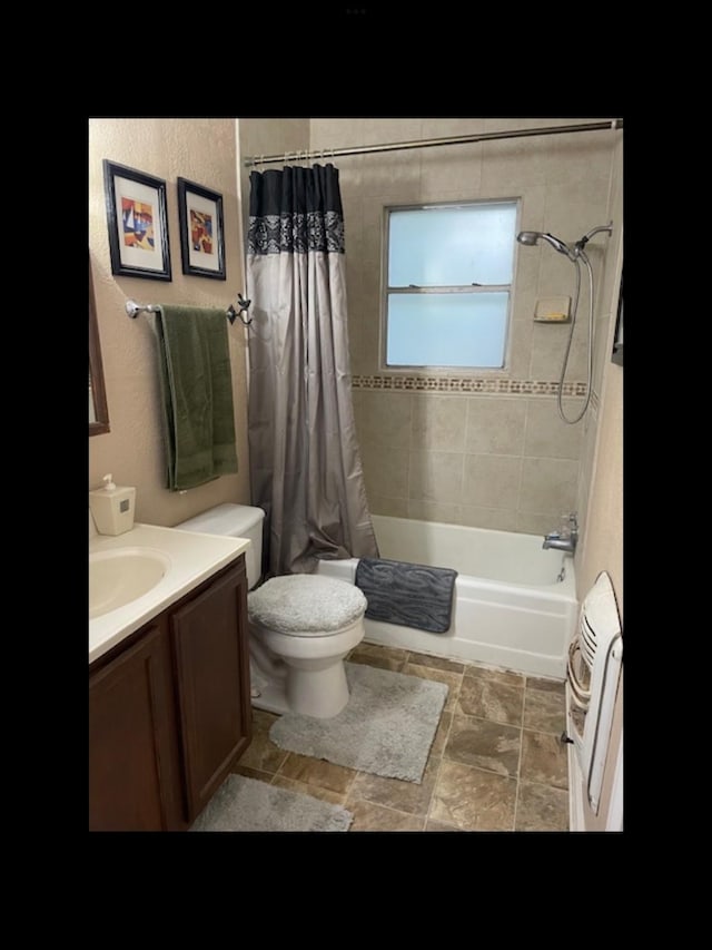 full bathroom featuring toilet, vanity, and shower / bath combo with shower curtain