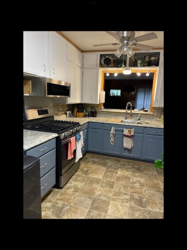 kitchen with sink, blue cabinetry, ceiling fan, appliances with stainless steel finishes, and white cabinetry