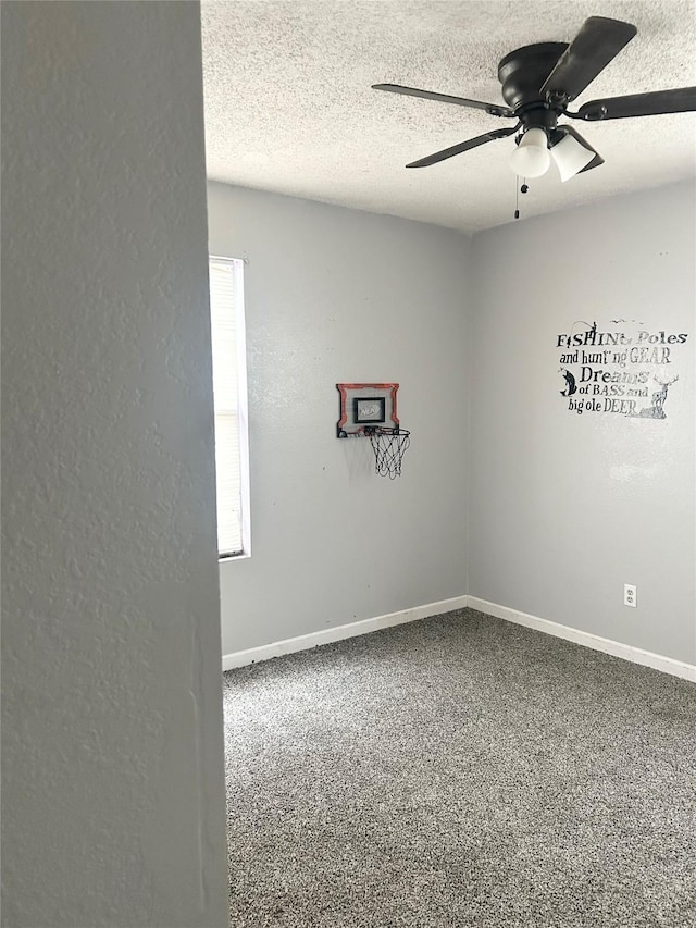 carpeted empty room with ceiling fan and a textured ceiling