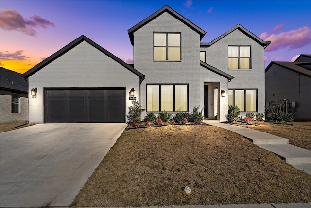 view of front of house featuring a garage, driveway, and brick siding