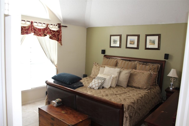 carpeted bedroom featuring vaulted ceiling