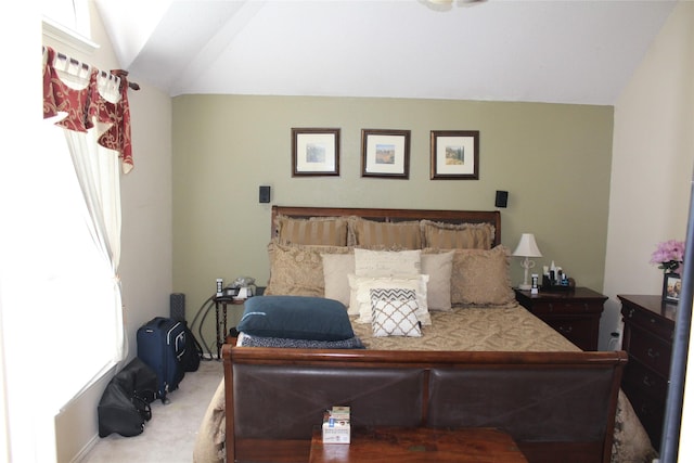 bedroom with carpet flooring and vaulted ceiling